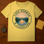 Yellow t-shirt with Lake Norman, N.C. circular graphic featuring sunset over water and trees.