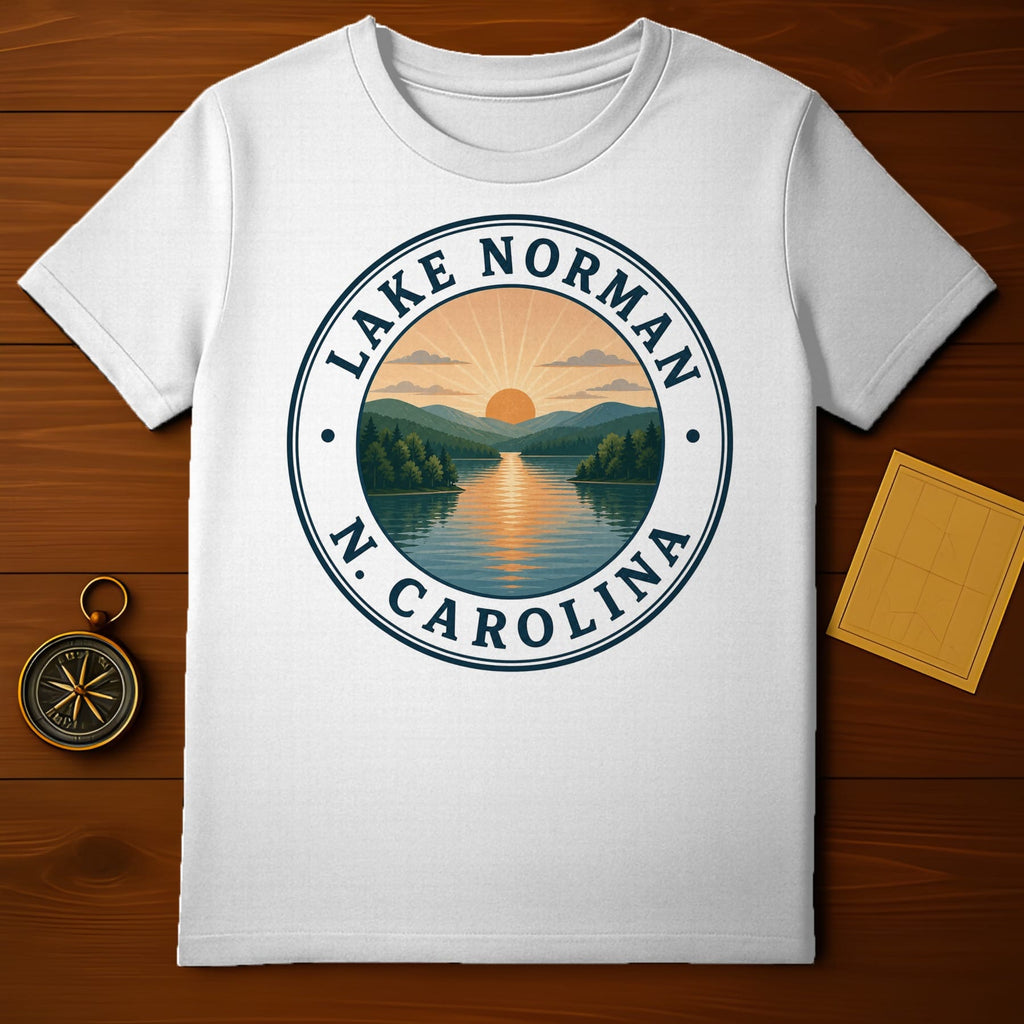 White t-shirt featuring Lake Norman, N.C. circular emblem with sunset over water and mountains.