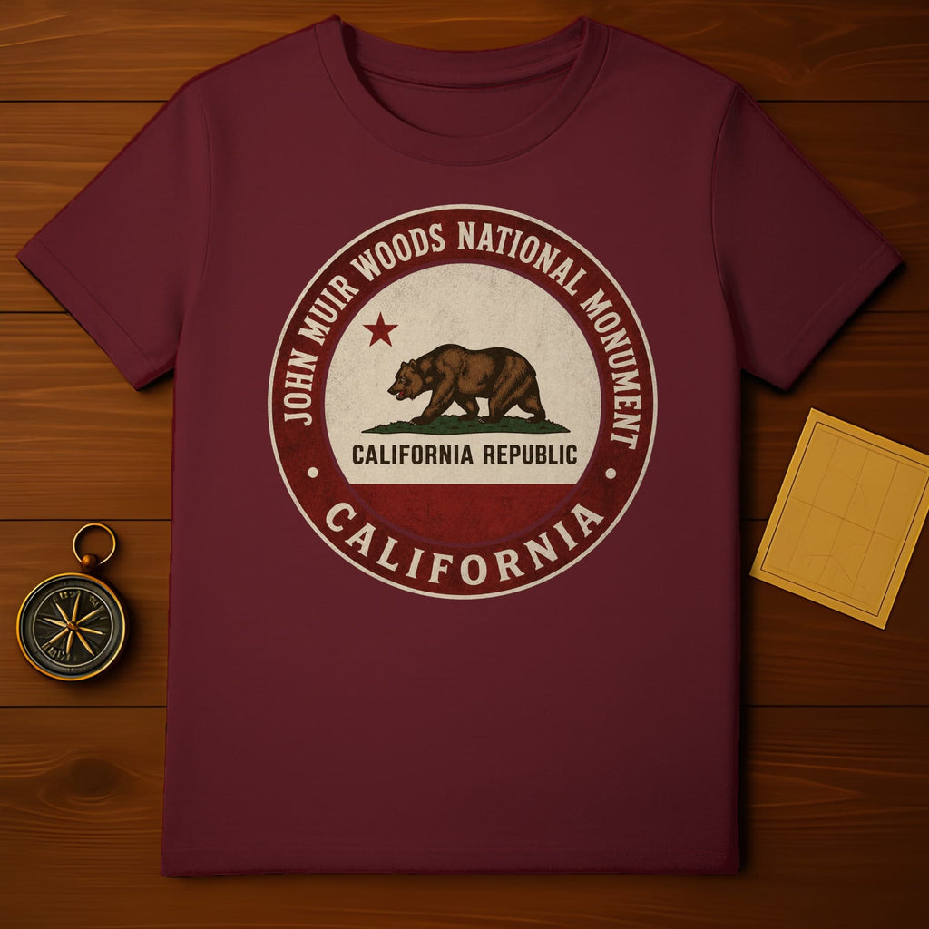 Maroon t-shirt featuring a circular emblem with a bear and "John Muir Woods National Monument California Republic".