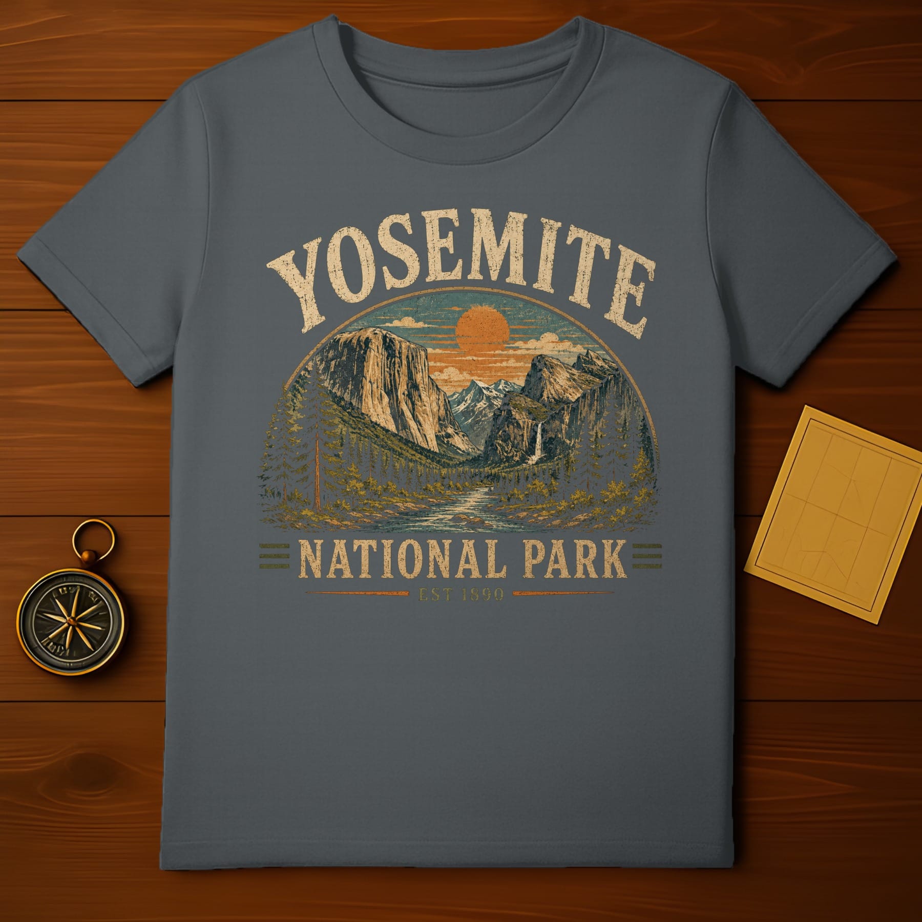 Yosemite National Park graphic on a dark grey t-shirt with vintage sunset landscape.