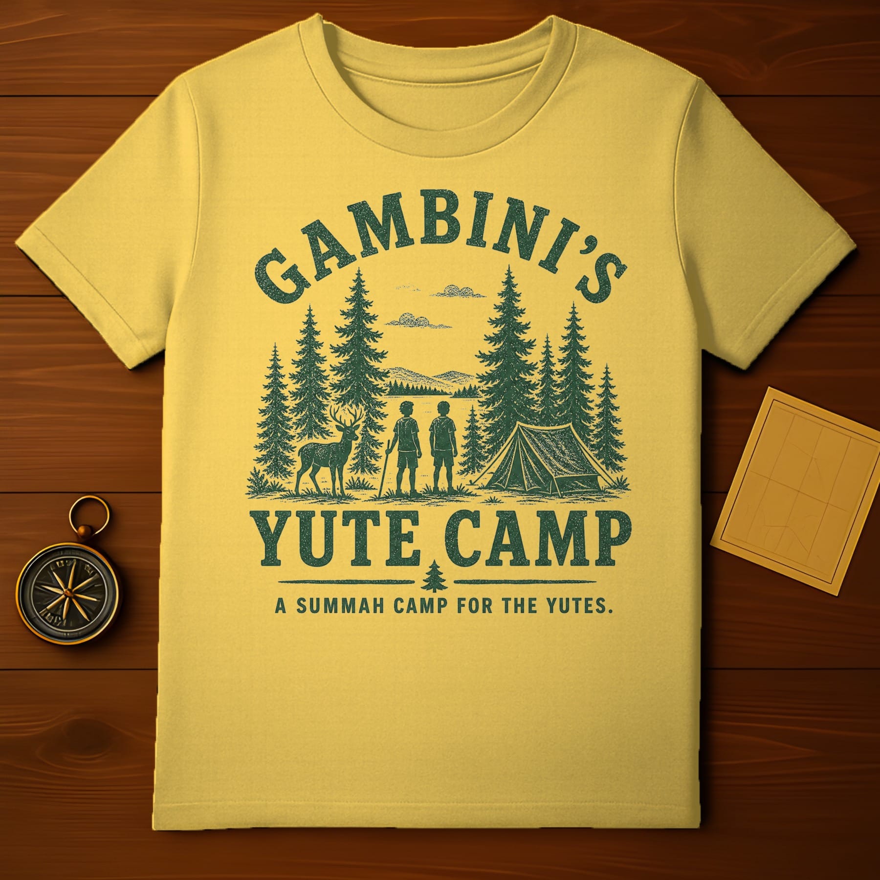Yellow t-shirt with "Gambini's Yute Camp" text and forest graphic.