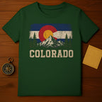 Green t-shirt with distressed Colorado flag design featuring mountains and trees.