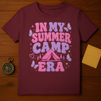 Maroon t-shirt with "In My Summer Camp Era" text and camping graphics.